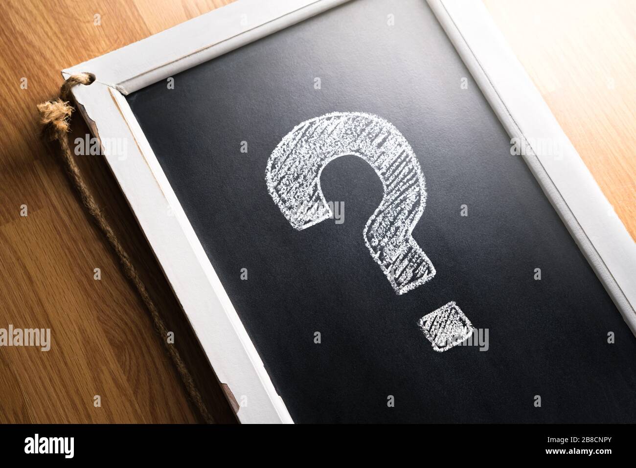 Question mark drawn on chalkboard.  About us, help or info for business. Survey, poll or quiz concept. Punctuation, decision, feedback or education. Stock Photo