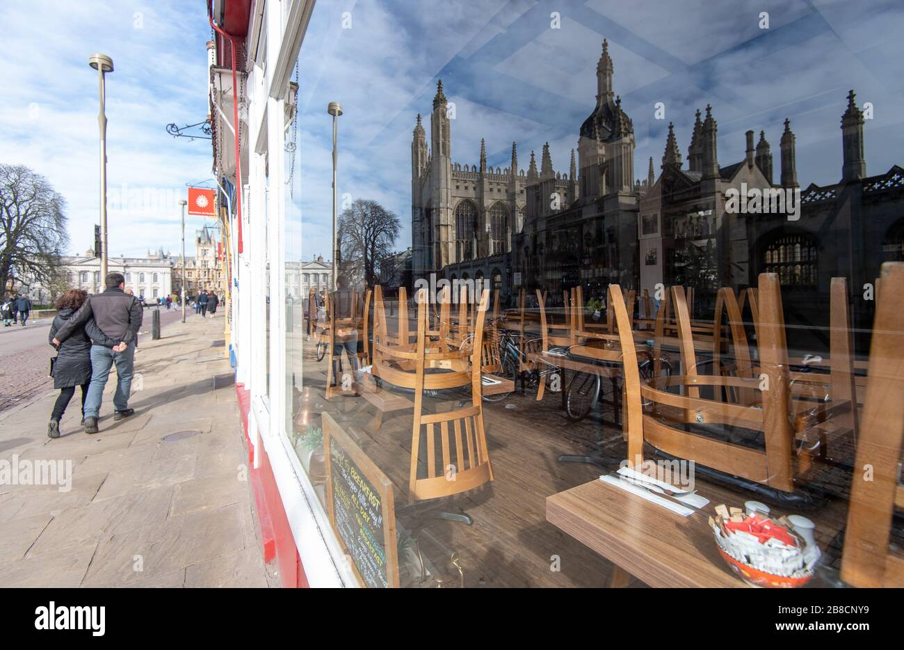King's College is reflected in the window of a closed cafe in Cambridge, after Prime Minister Boris Johnson ordered pubs, restaurants, leisure centres and gyms across the country to close as the Government announced unprecedented measures to cover the wages of workers who would otherwise lose their jobs due to the coronavirus outbreak. Stock Photo