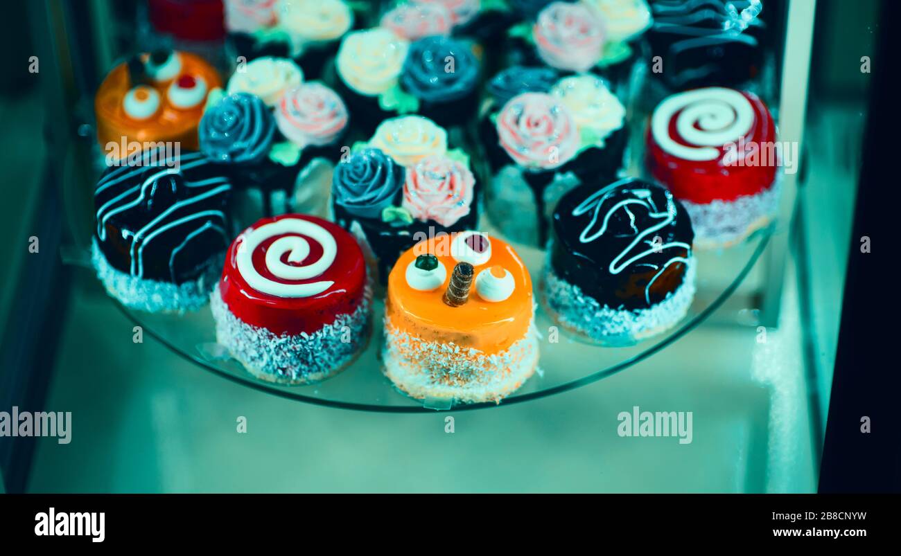 Close up view of various sweet cupcakes, selectively focused, against a bokeh background. Stock Photo