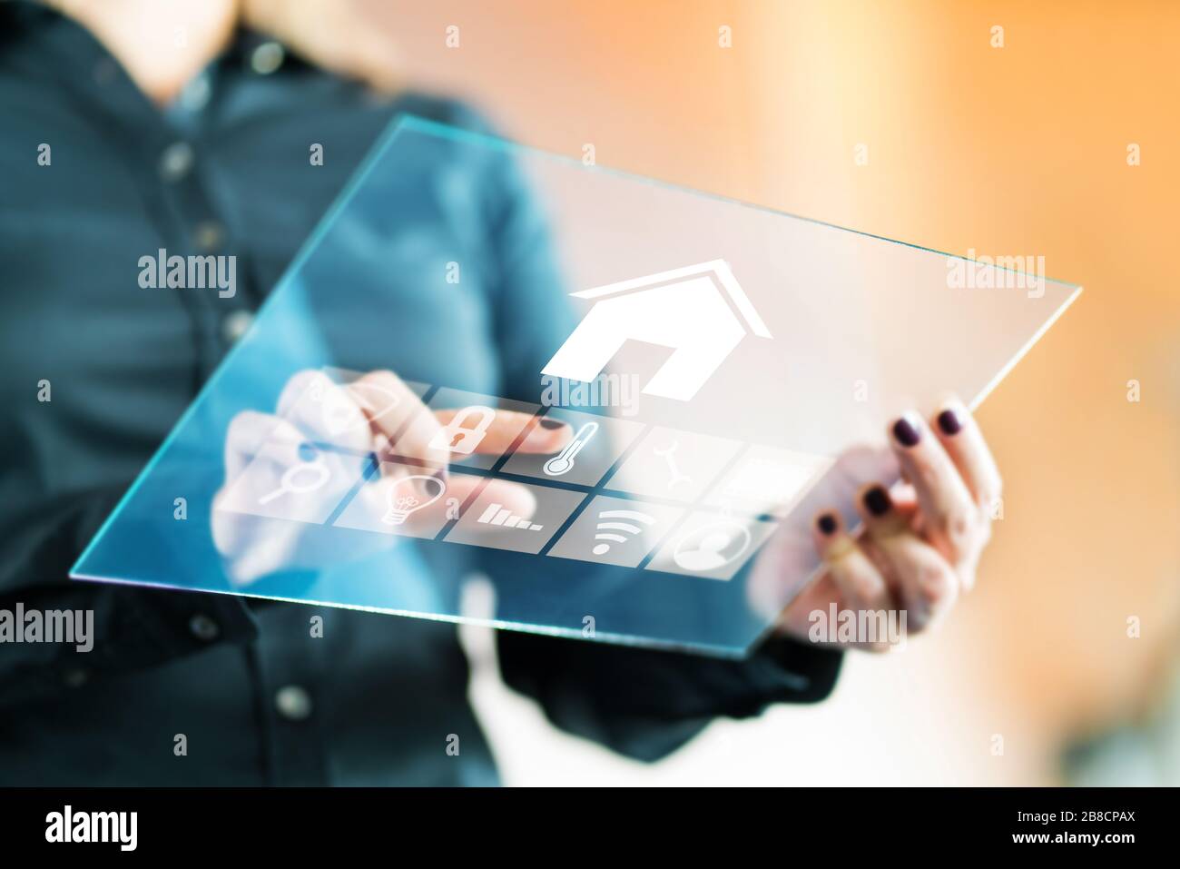 https://c8.alamy.com/comp/2B8CPAX/woman-using-smart-home-control-application-with-futuristic-transparent-glass-tablet-finger-touching-button-to-control-property-2B8CPAX.jpg