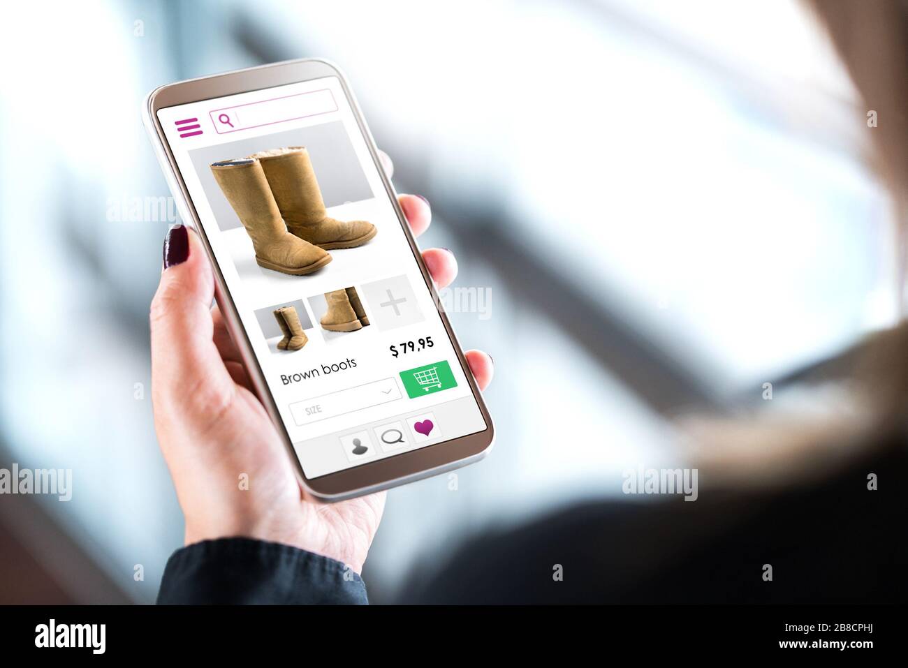 Female customer shopping in online fashion store with mobile phone. Woman buying shoes or boots with smartphone. Internet sale on website in cellphone. Stock Photo