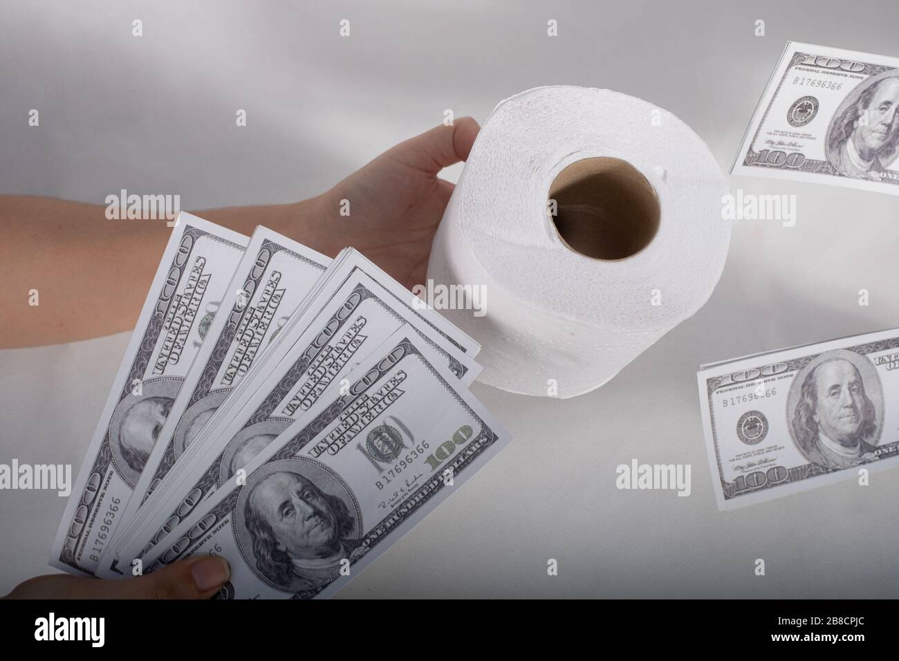 Close up sell-buy tissue, handholds toilet paper tissue and money of 100 US  dollars banknote a lot of Stock Photo - Alamy