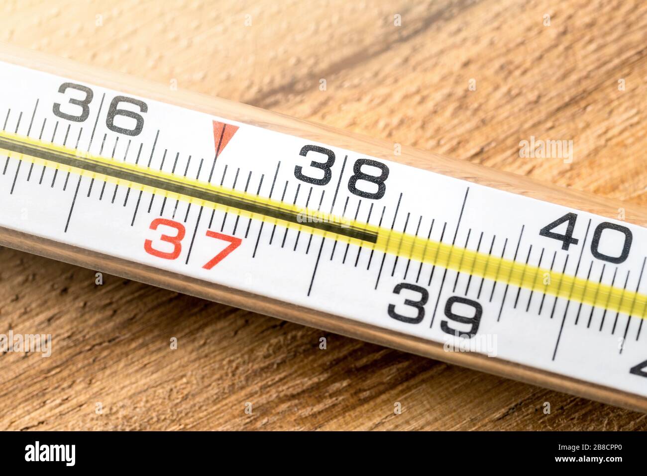 High fever and body temperature. Having fever, flu, sickness, virus and being sick concept. Macro close up of thermometer with celsius numbers. Stock Photo