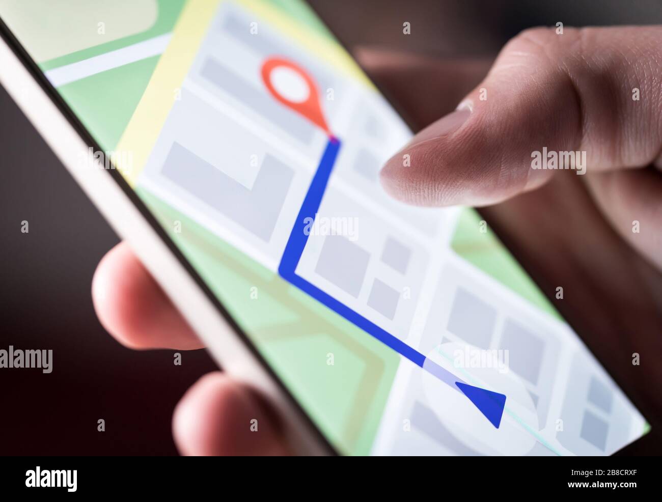 Map application in smartphone. Man navigating in city with mobile phone. Person using cellphone and searching hotel with navigation app. Stock Photo