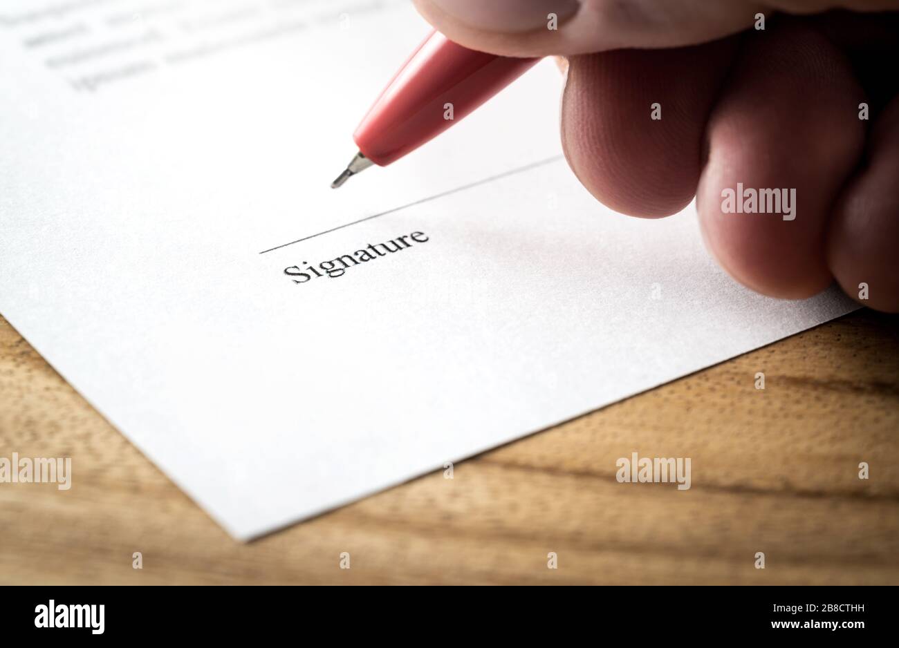 Writing signature. Man signing settlement, contract or agreement for employment and hiring, business acquisition and buyout, car lease or real estate. Stock Photo