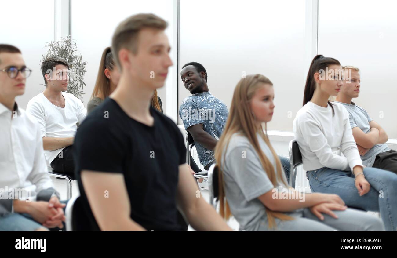 diverse young people applauding while sitting in the same row Stock ...