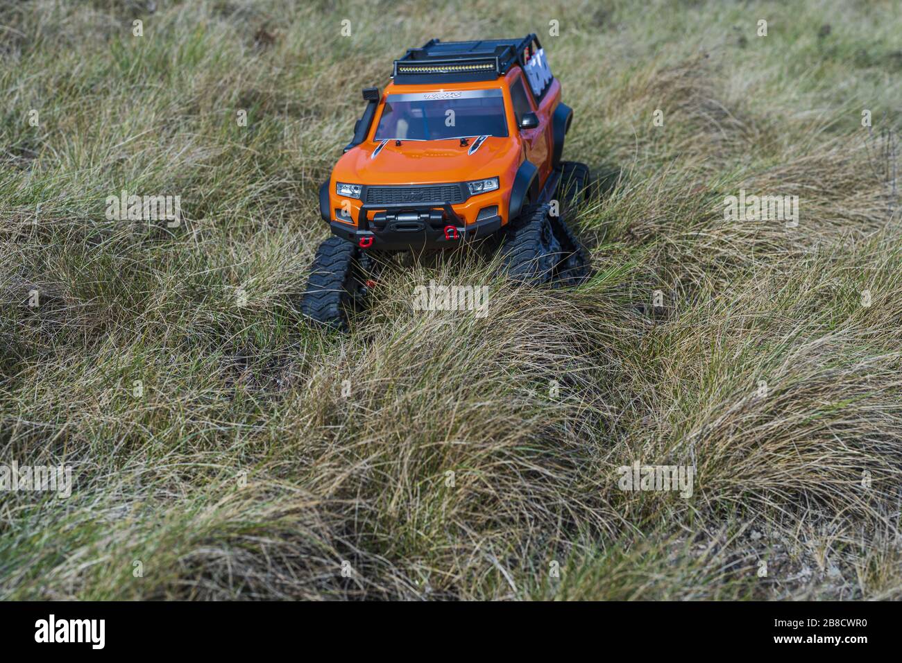 View of radio controlled model racing car on offroad background. Toys