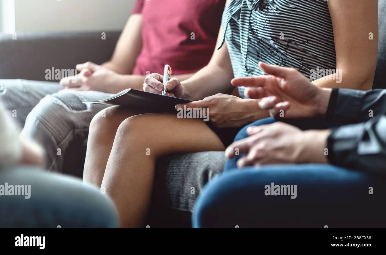 Group therapy meeting and counseling. Professional psychologist, psychiatrist or psychotherapist helping. Female leader. Alcohol or drug addiction. Stock Photo