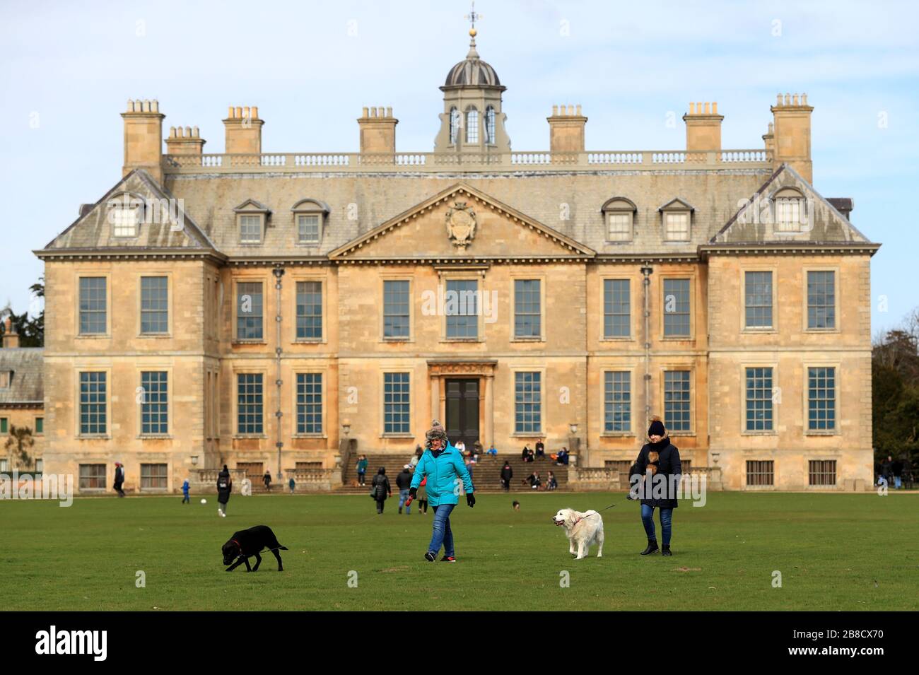 A general view of people waking around the grounds of Belton House in Grantham, which has been opened up free of charge after Boris Johnson ordered pubs, cafes, nightclubs, bars, restaurants, theatres, leisure centres and gyms to close to fight coronavirus. Stock Photo
