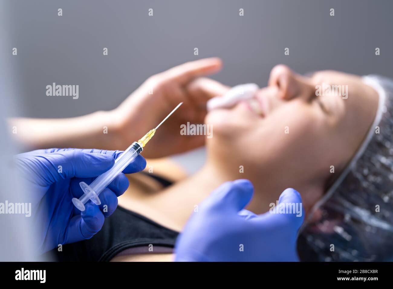 Plastic surgery fail concept. Unhappy customer in pain after lip augmentation.  Problem in beauty salon. Upset and sad woman after injecting lips. Stock Photo