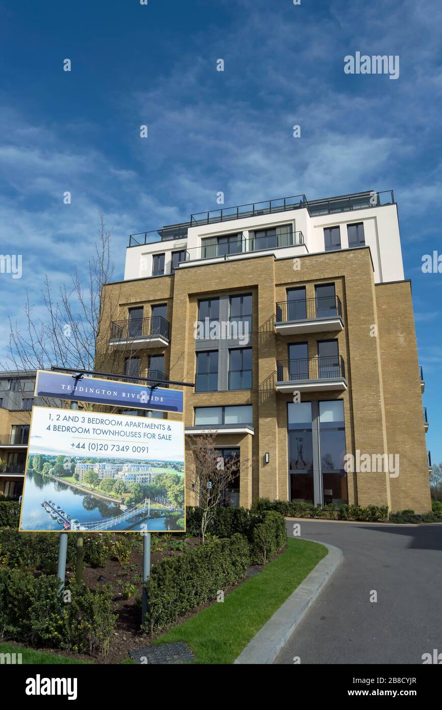 fronted by a sale board, teddington riverside, a development of apartments and townhouses beside the river thames in teddington, middlesex, england Stock Photo