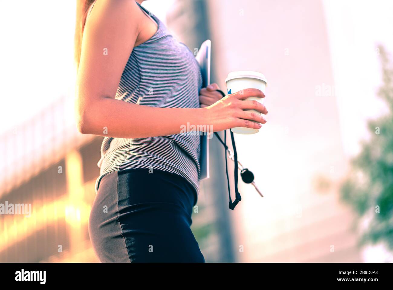 Confident businesswoman walking to work in city. Office worker, student, realtor or lawyer with coffee cup. Career woman. Corporate employee on lunch. Stock Photo