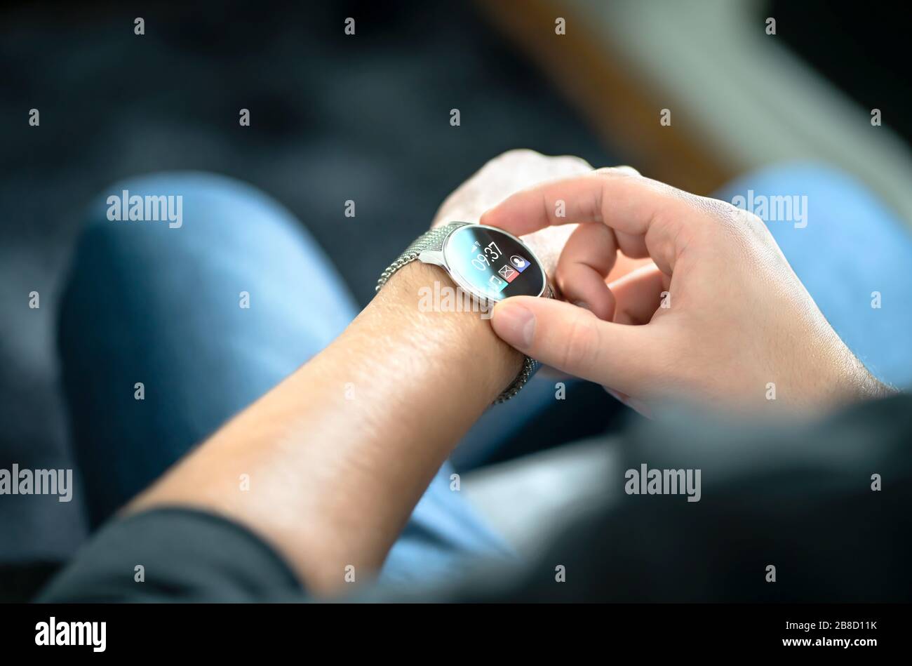 Smart watch, wearable gadget. Man wearing hybrid smartwatch. Wearables with digital touchscreen and mobile app technology. Person using wristwatch. Stock Photo