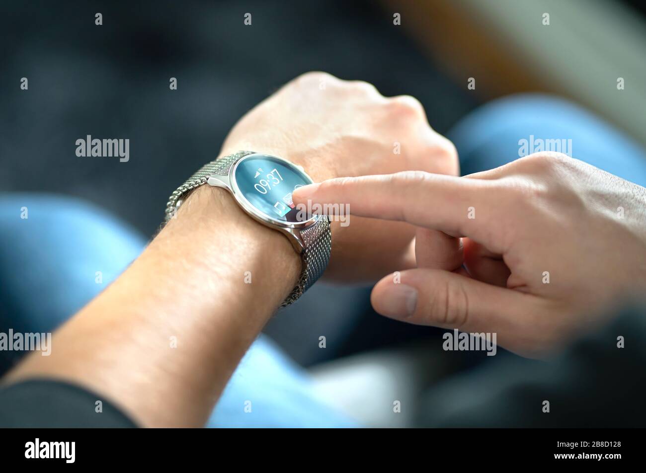 Man touching smart watch screen to open notification and read message. Wearable hybrid mobile device, gadget and activity tracker in wrist. Stock Photo