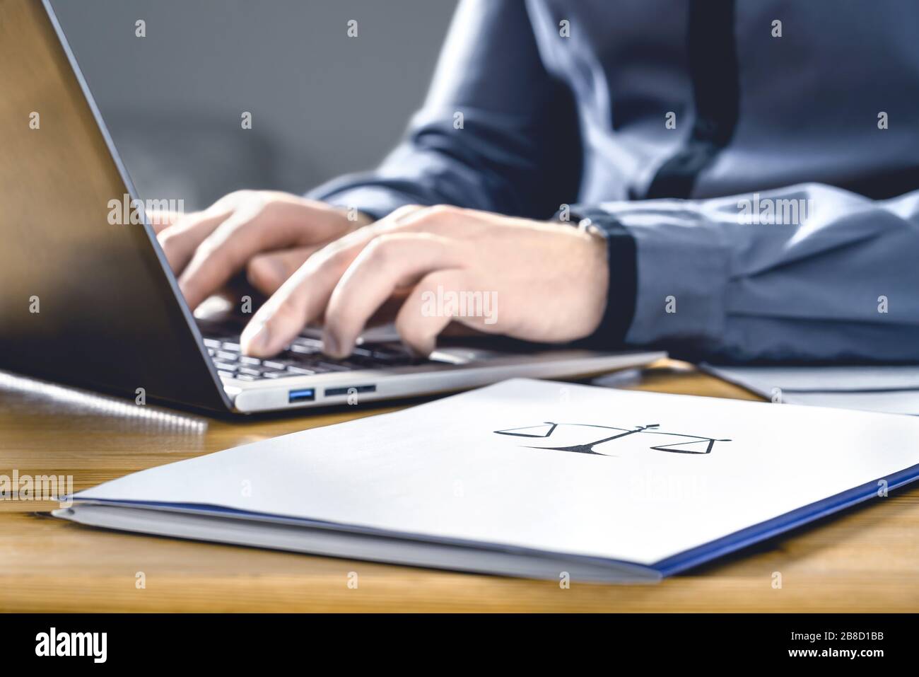 Legal worker in law firm with laptop computer. Attorney, prosecutor or solicitor working on a legislation case. Stock Photo