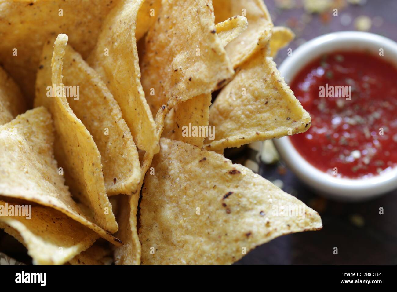 Concept of mexican cuisine. Tortilla chips in a bowl with tomato salsa. Top view. Stock Photo