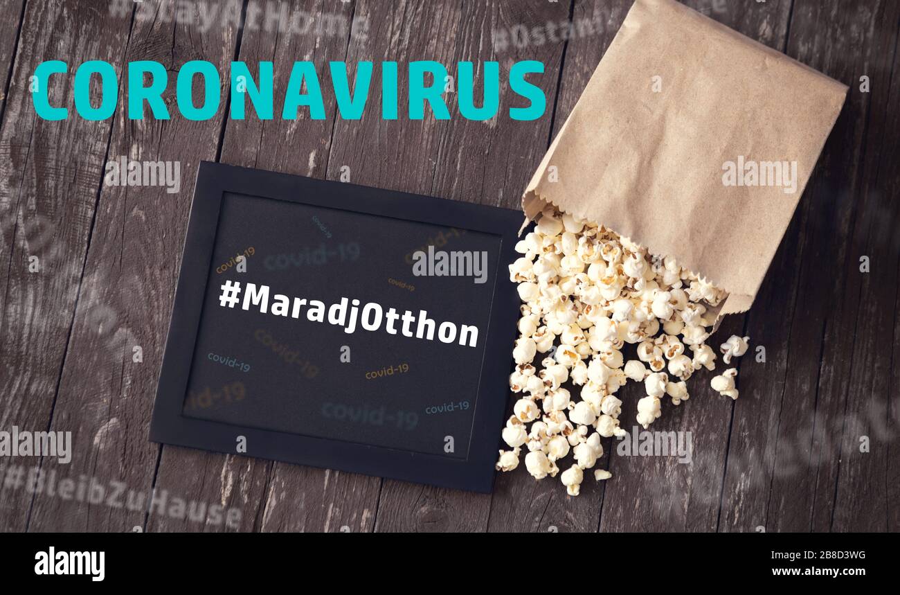 popcorn with sign about stay at home in time of global influenza pandemiv coronavirus. Isolation, quarantine, awareness, covd-19 concept. movie time Stock Photo