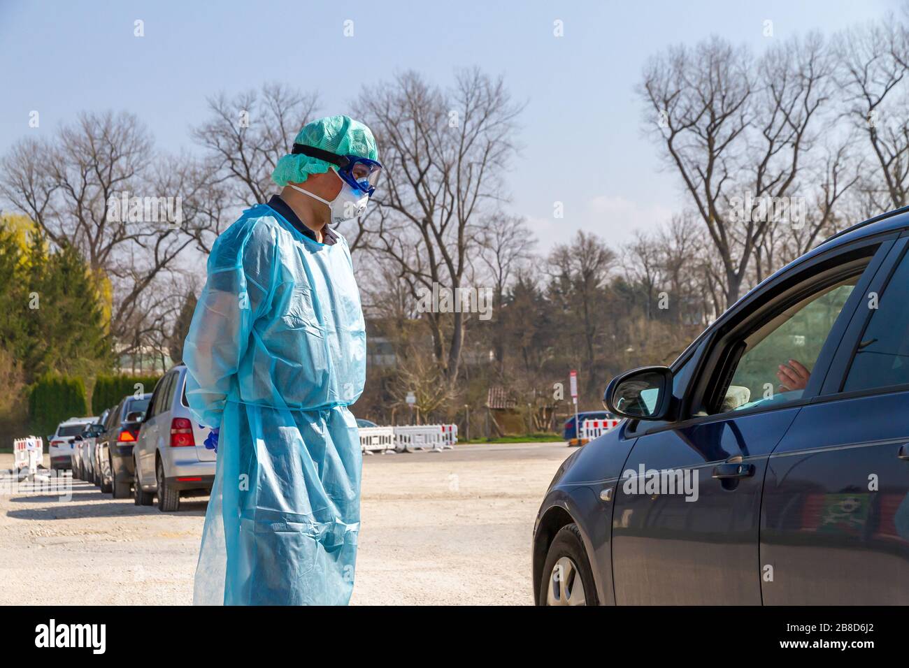 Doctor on a cornavirus test station talking with patient in a car Stock Photo