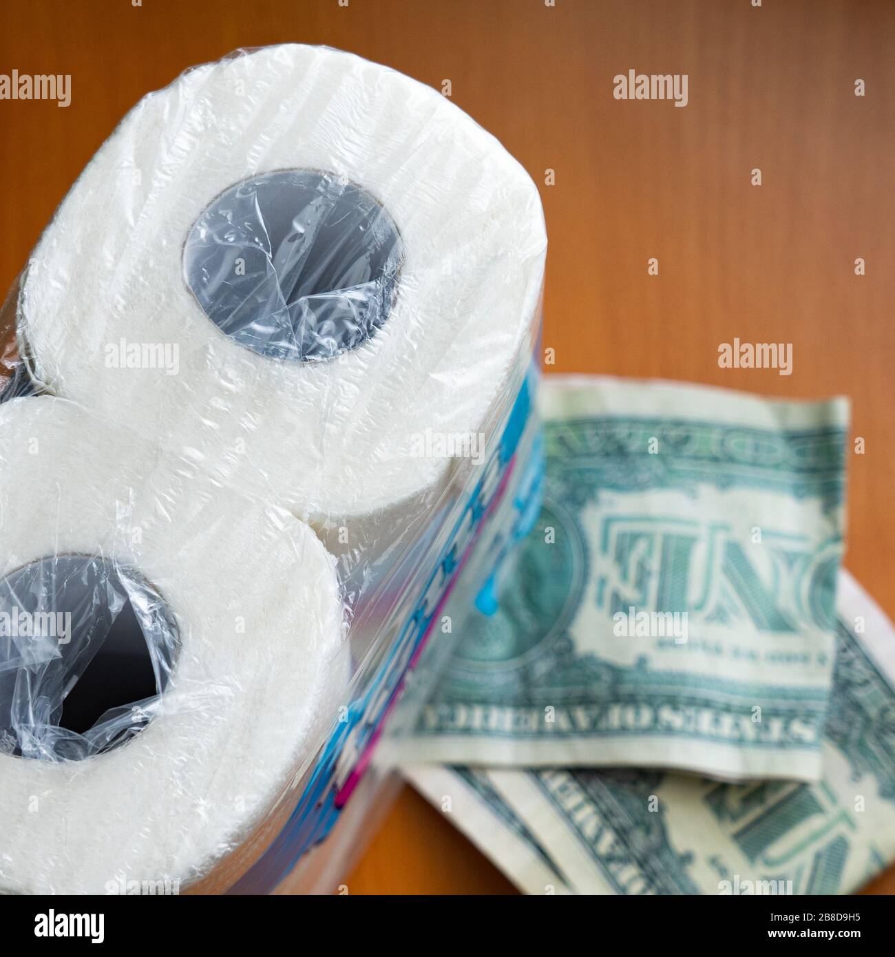 Dollar in toilet paper roll Stock Photo Alamy