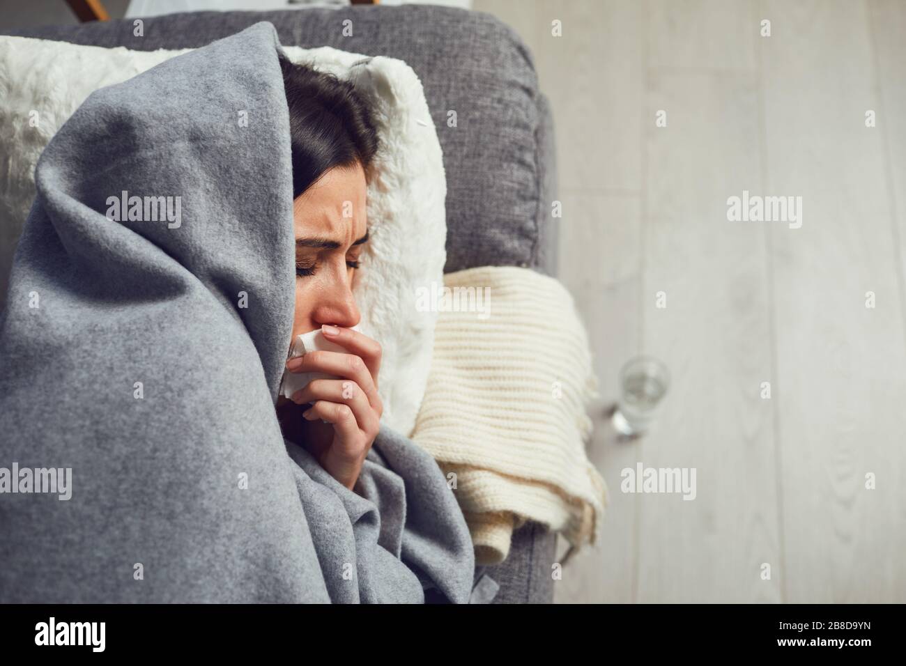 Quarantine.Coronavirus. Woman with coronavirus symptoms lying on quarantine at home sofa. Stock Photo