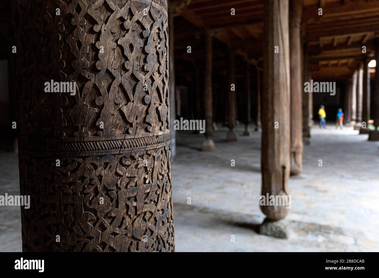 Uzbekistan, Khiva, Mother and son standing at he wood columns inside of the old Juma mosque inside, Uzbekistan Stock Photo