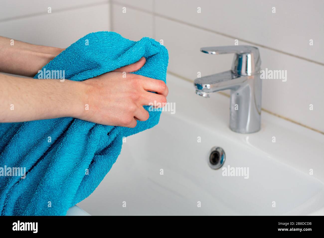 Person Using Towel Wiping Hands Dry Washing Bathroom Home Hygiene Stock  Photo by ©goffkein 330686390