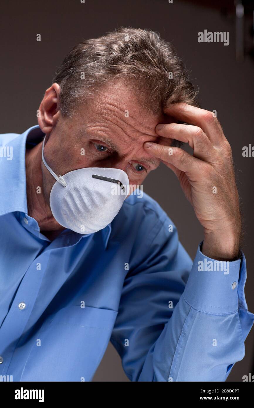 Thoughtful worried physician with medical mask in a hospital Stock Photo