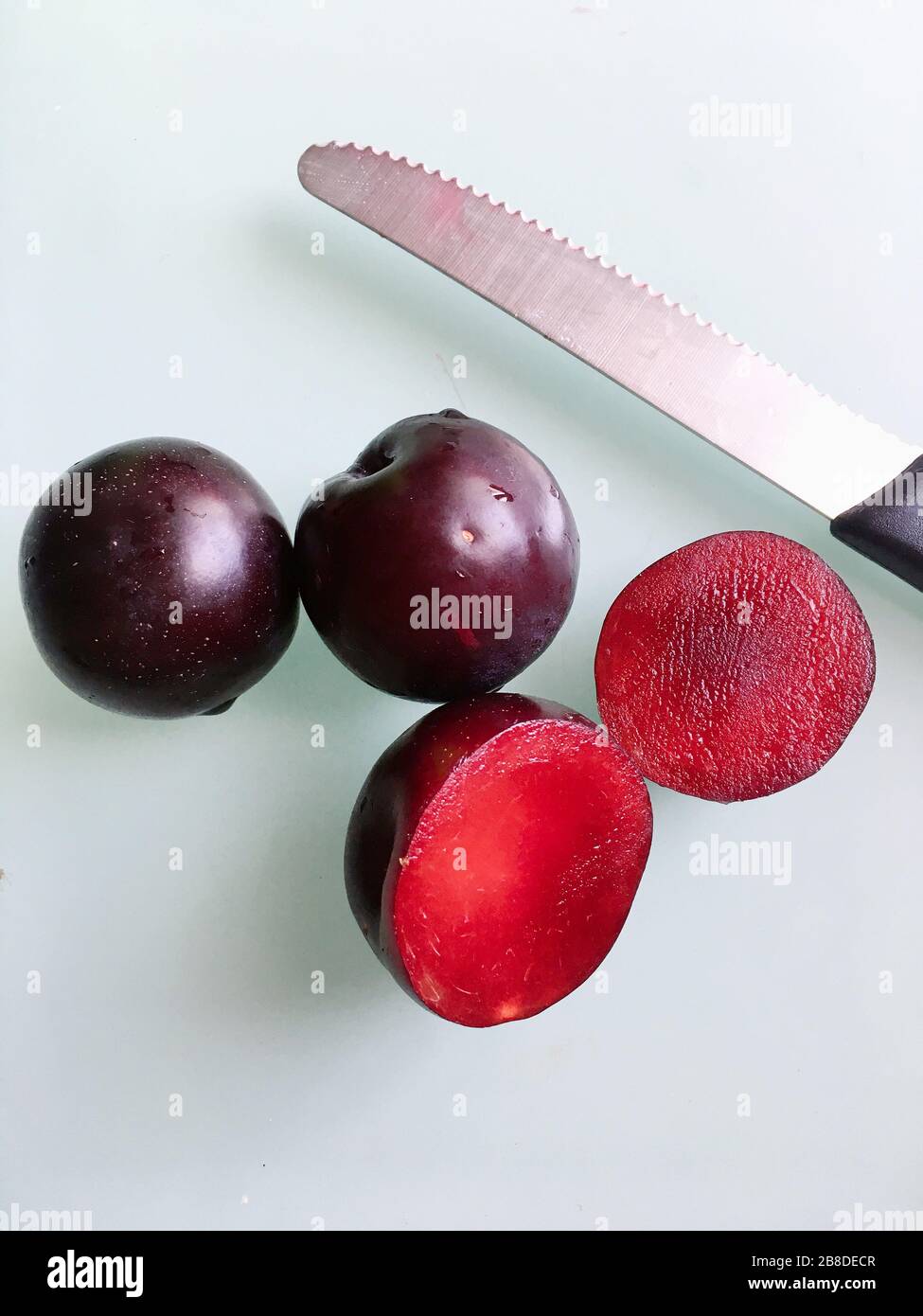 Half-cut pluot plum fruits Stock Photo