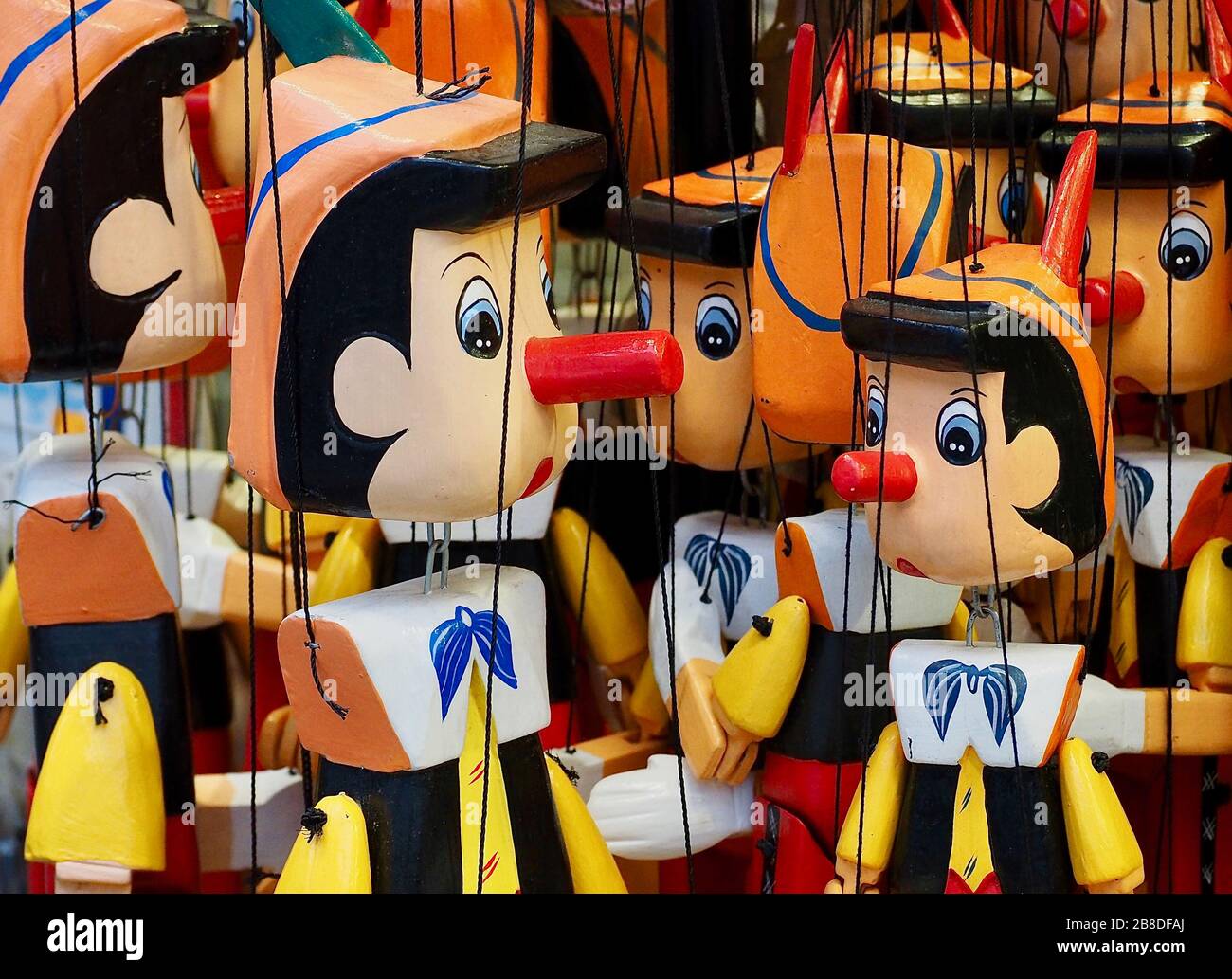 Macro of Pinocchio puppets hanging on strings Stock Photo Alamy