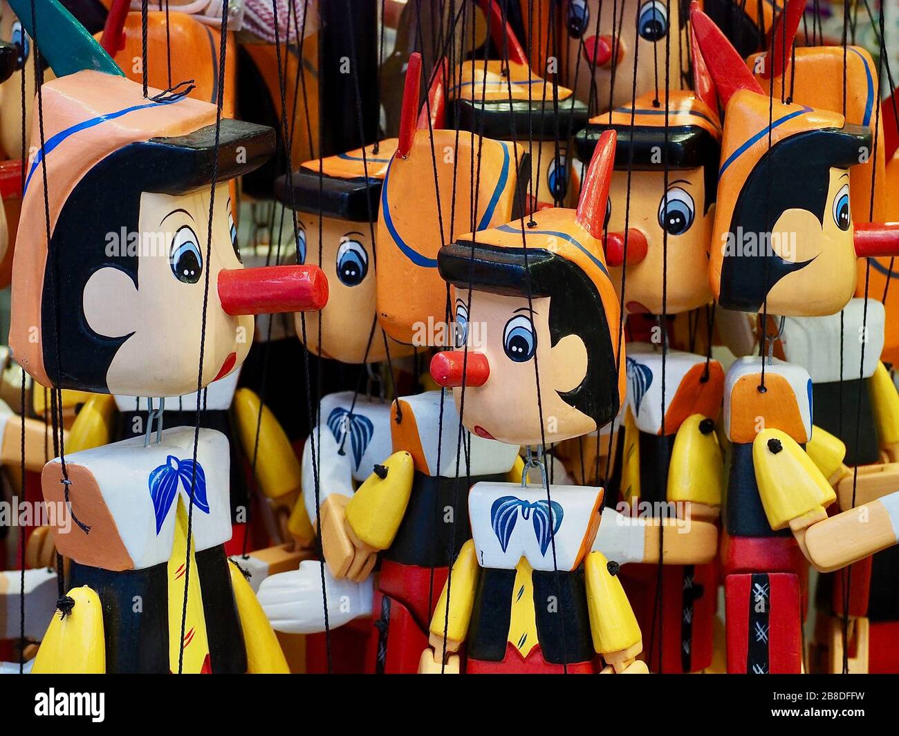 Macro of Pinocchio puppets hanging on strings Stock Photo Alamy