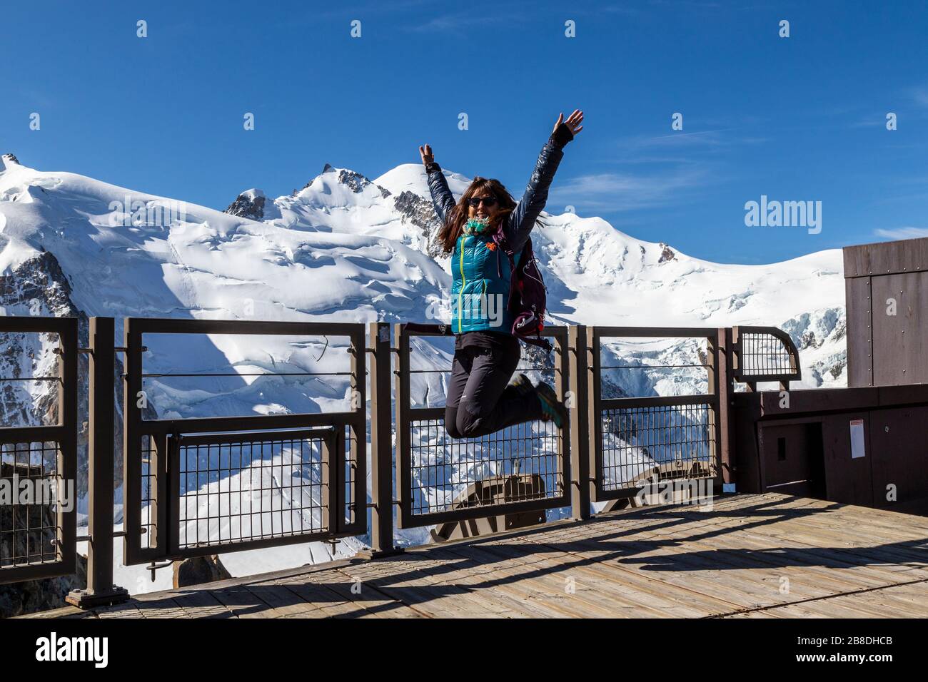 Jump in the viewpoint of Aiguille du Midi in Chamonix with the Montblanc mountain in the background Stock Photo