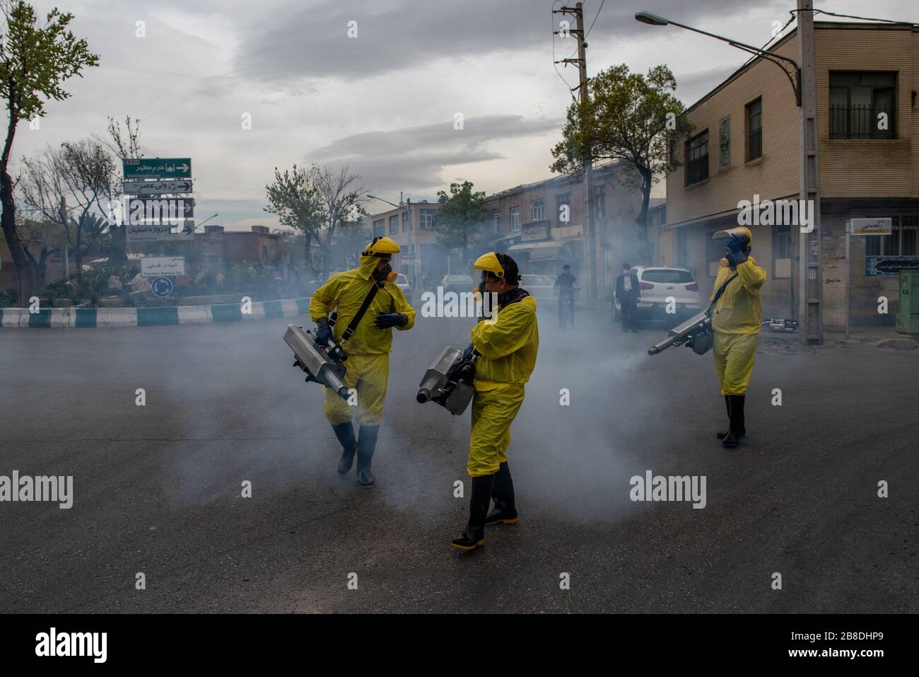 The Iranian health ministry, provincial fire department and municipal staffs disinfect the streets and other public places against Coronavirus using machinery and mobile pumps in Shiraz, Iran, Mar. 2020. Stock Photo