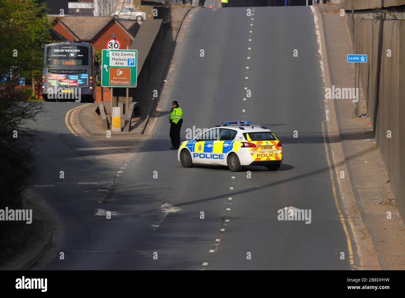 A Police vehicle diverts traffic by blocking the road, due to a man threatening to jump from a bridge in Leeds. Stock Photo