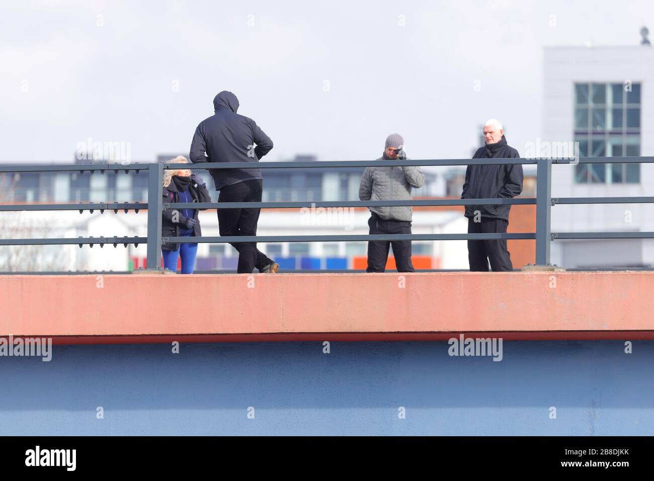 A man who threatened to throw himself off a bridge in Leeds, is seen speaking to negotiators, who managed to talk him to safety after 4 hours Stock Photo