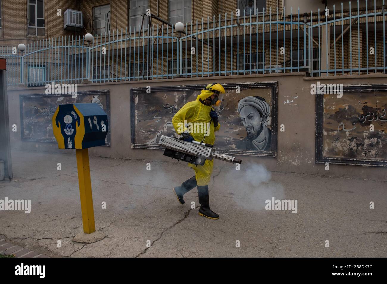 The Iranian health ministry, provincial fire department and municipal staffs disinfect the streets and other public places against Coronavirus using machinery and mobile pumps in Shiraz, Iran, Mar. 2020. Stock Photo