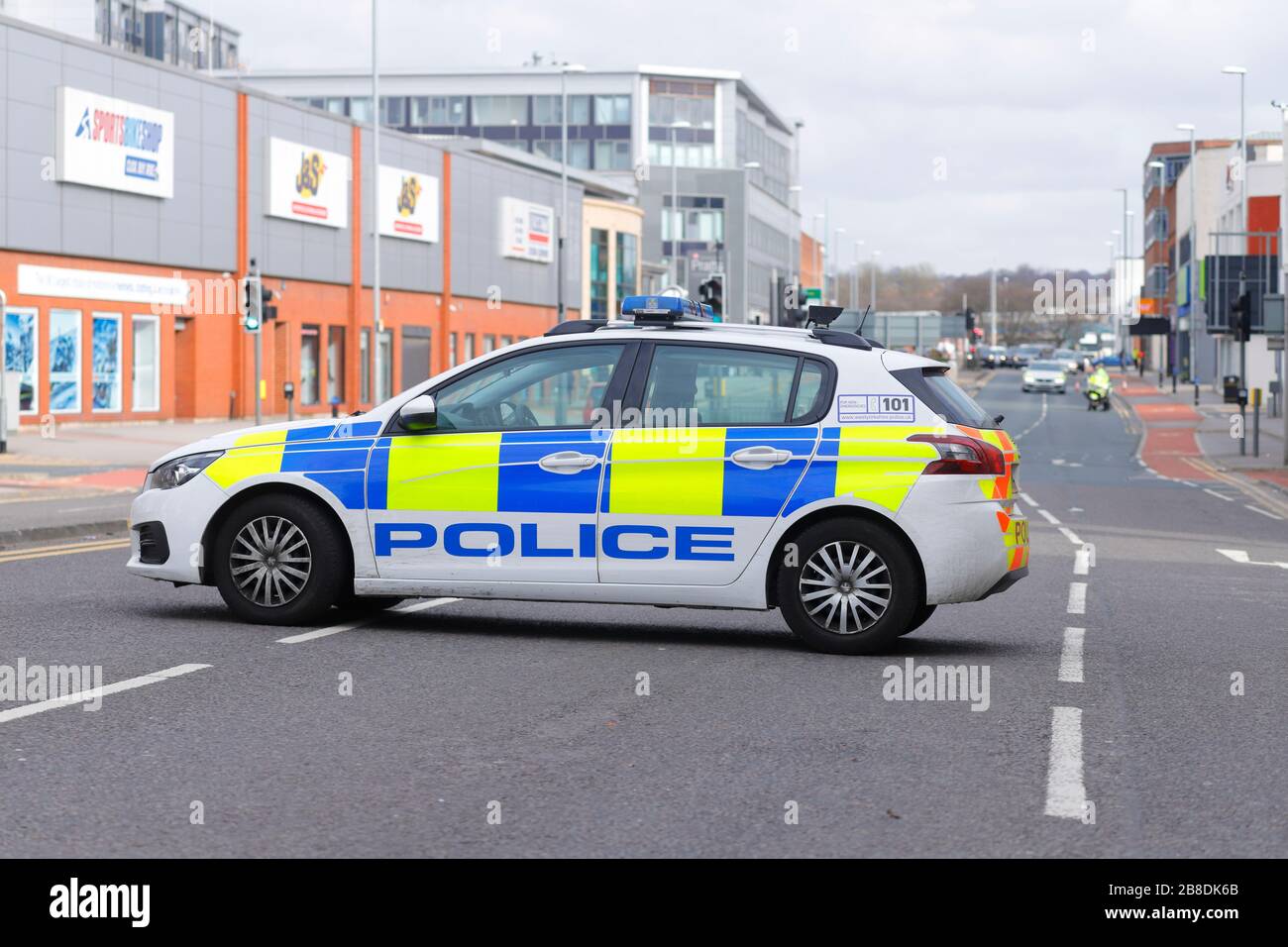 A Police vehicle diverts traffic by blocking the road, due to a man threatening to jump from a bridge in Leeds. Stock Photo