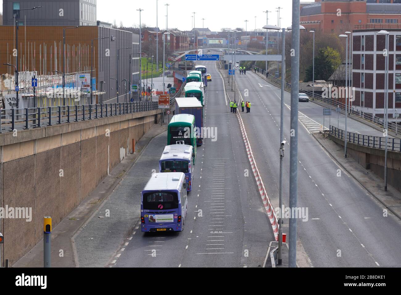 A suicidal man threatens to jump from a busy motorway bridge in Leeds, which resulted in the road being closed. The man was talked to safety. Stock Photo