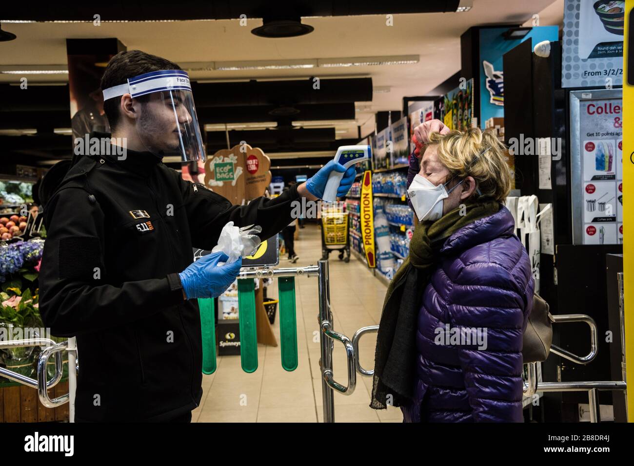 Spinneys, Beirut, Lebanon. 21st Mar, 2020. In an effort to slow the spread of COVID19, a member of staff scans all shoppers' foreheads with a temperature scanner before they enter the supermarket. Those with a temperature above 38 degrees celcius are given gloves to wear while they shop. Credit: Elizabeth Fitt/Alamy Live News Stock Photo