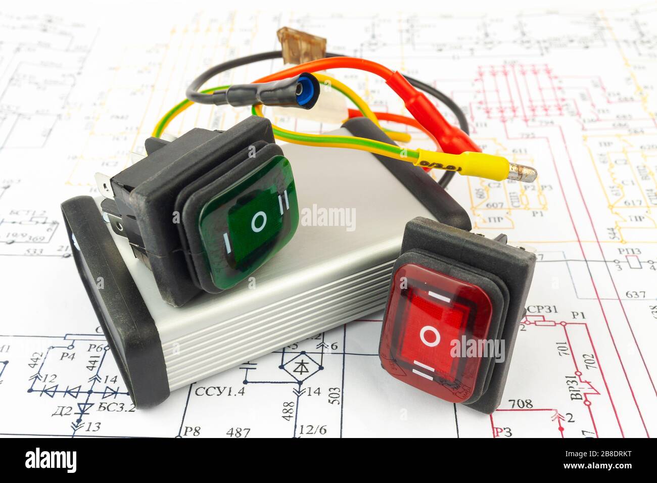 The electronic block and switches lie on a paper electronic circuit. Stock Photo