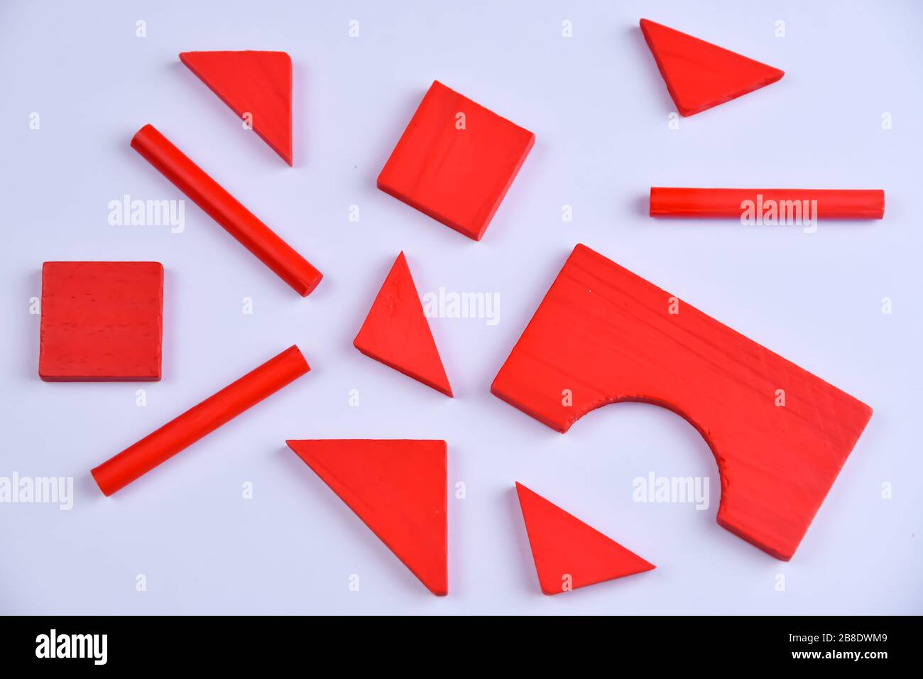 Bright red wooden constructor details for children for the development and education on a white background Stock Photo