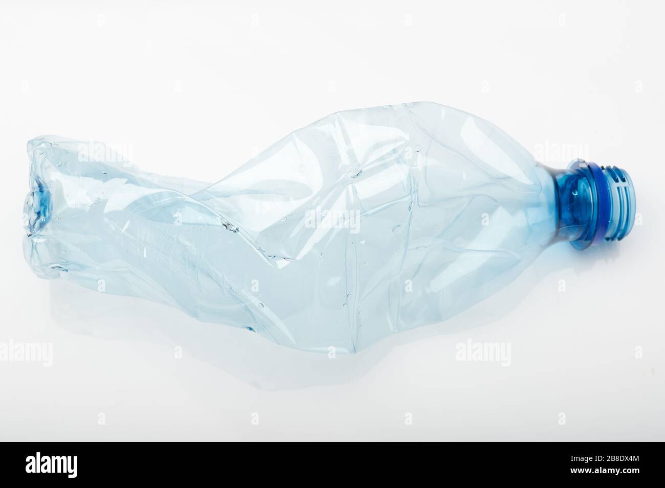 Plastic recycle theme. One empty squashed transparent bottle Stock Photo