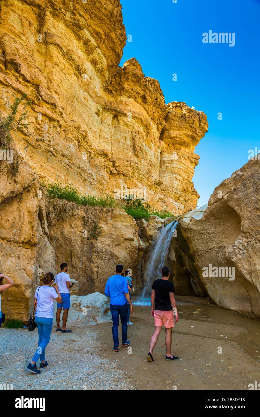 People in a waterfall in a mountain oasis. Stock Photo