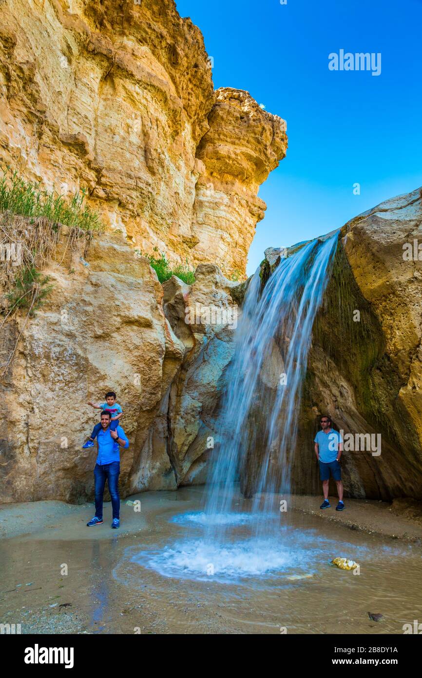 People in a waterfall in a mountain oasis. Stock Photo