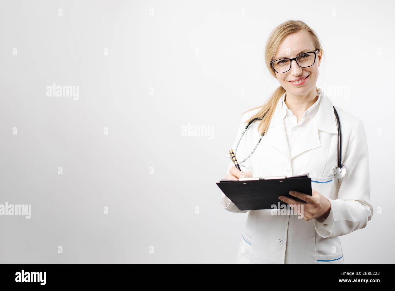 Medical expert posing in studio with clipboard Stock Photo