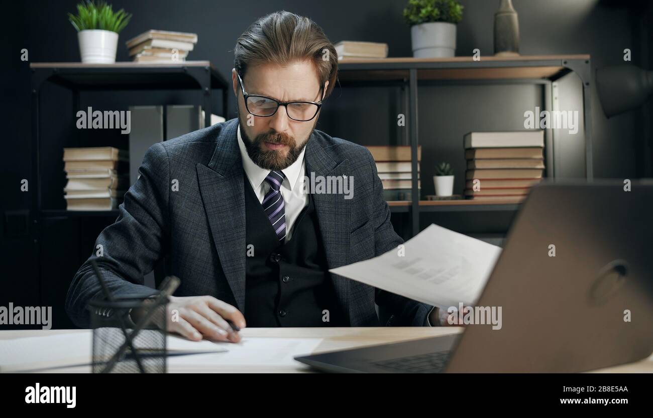 Mature businessman verifying data Stock Photo