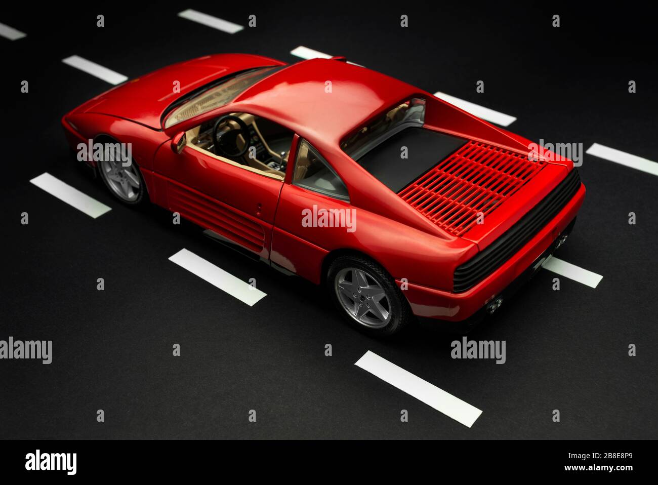 Izmir, Turkey - July 28, 2019: Old fashion Red sports toy car on a road with lanes from rear view. Stock Photo