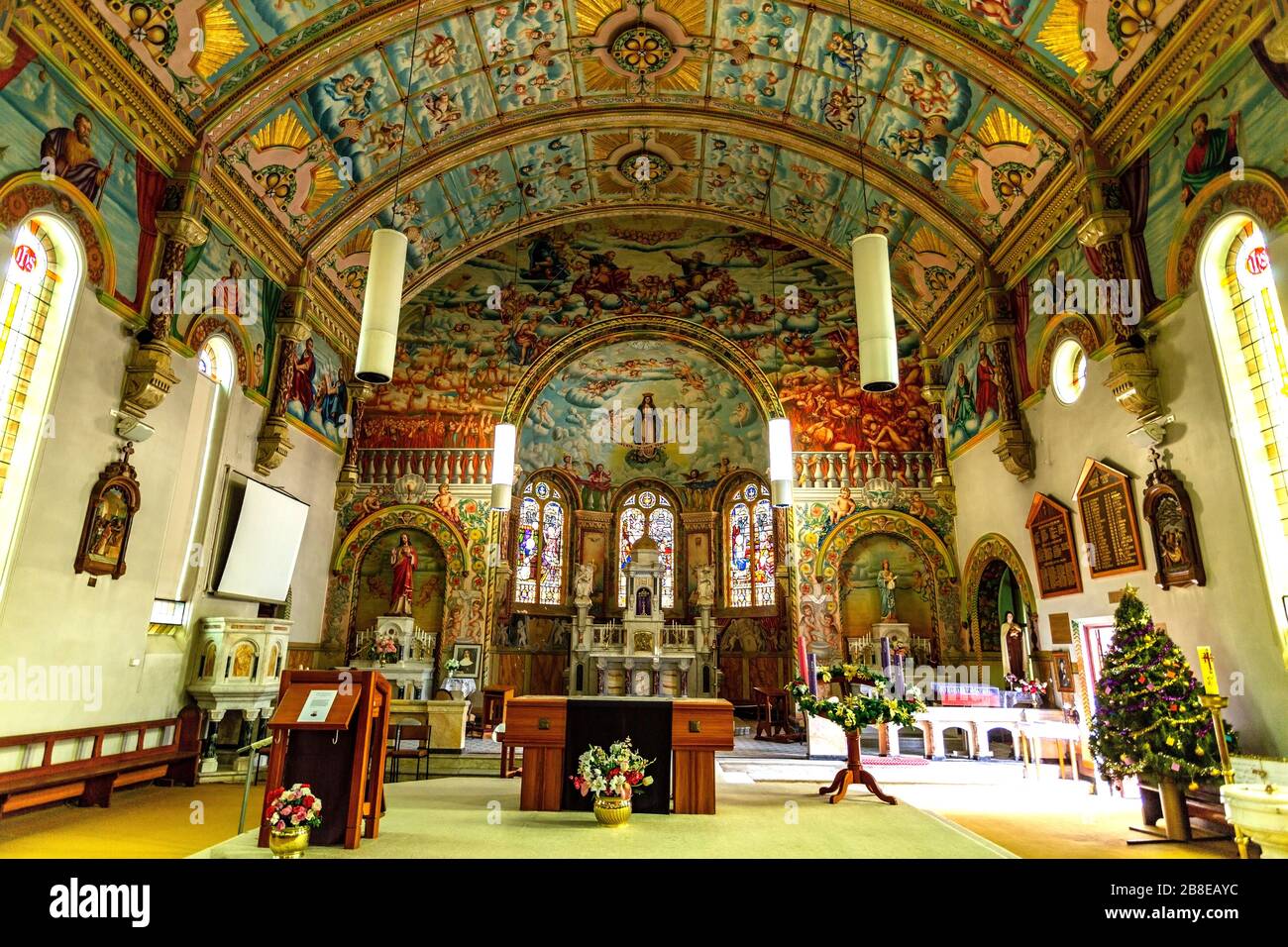 View of the interior of the Church of St Mary and its murals covering walls and ceiling depicting saints, the trinity, hell, purgatory, heaven and cru Stock Photo