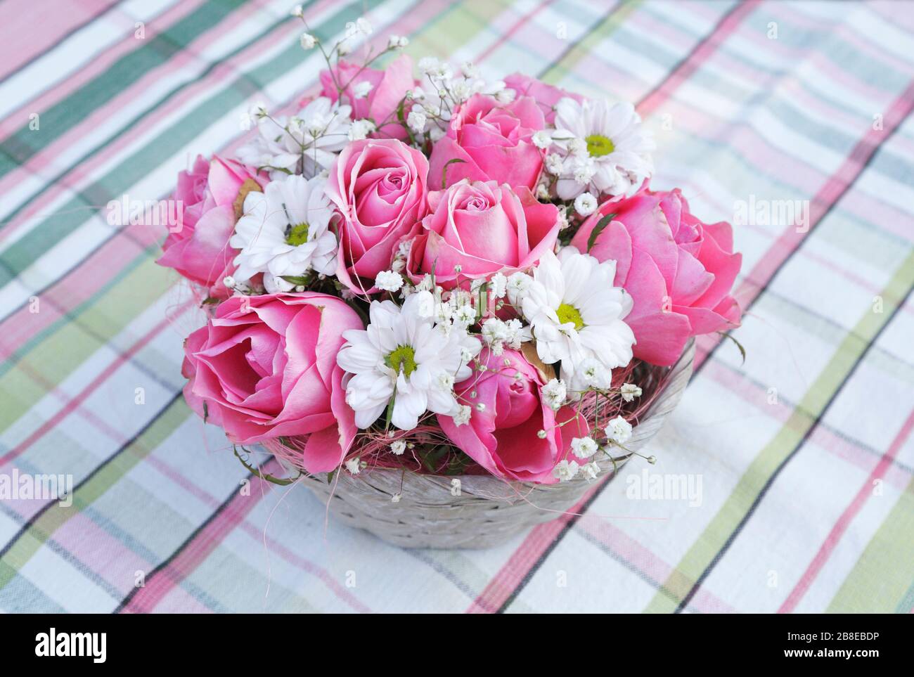 Roses, Chrysanthemum, and Gypsophila arranged in a basket, August Stock Photo
