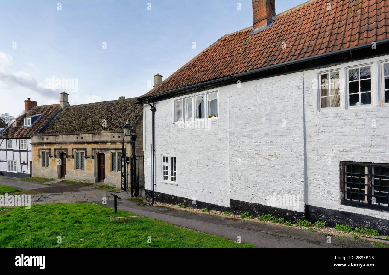16th century house & 19th century Cottages in St John's Churchyard with Iron Churchyard Gates, Devizes, Wiltshie, UK Stock Photo