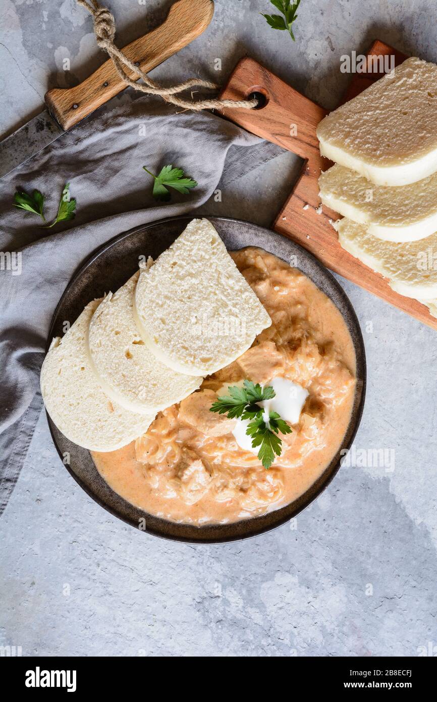 Classic Hungarian Szegedin pork goulash with dumplings on a ceramic